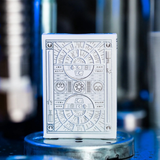 Playing card deck with intricate design on a metallic stand against a blurred background