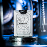Star Wars playing cards packaging on a reflective surface with blurred lights in the background
