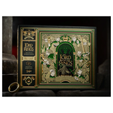Lord of the Rings: The Land of Middle Earth jigsaw puzzle box, featuring intricate green and gold fantasy artwork with a ring at the bottom left, set against a dark, moody background.