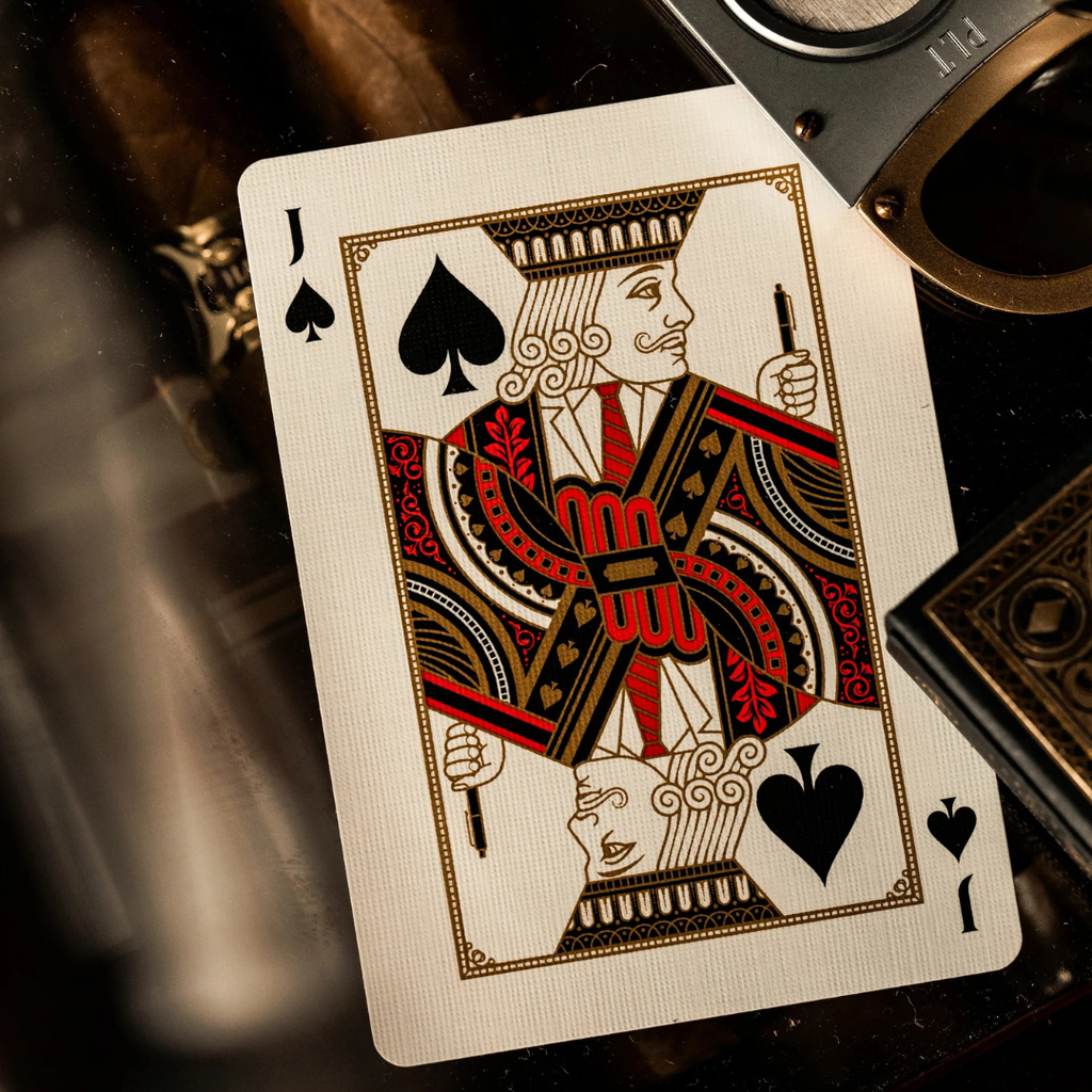 Jack of Spades playing card with a pen on a dark background